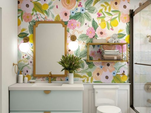 Bright bathroom with floral wallpaper, a mirror, sink, and modern fixtures.