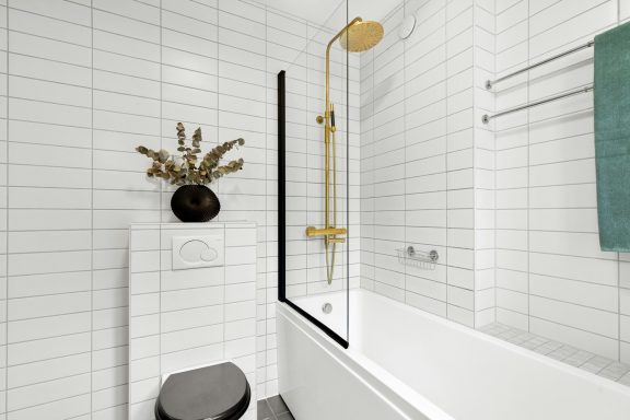 Modern bathroom featuring a bathtub, shower, and stylish design elements.