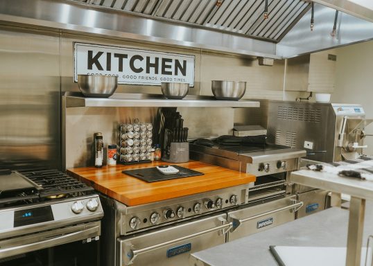 Modern kitchen with stainless steel appliances and a wooden countertop.